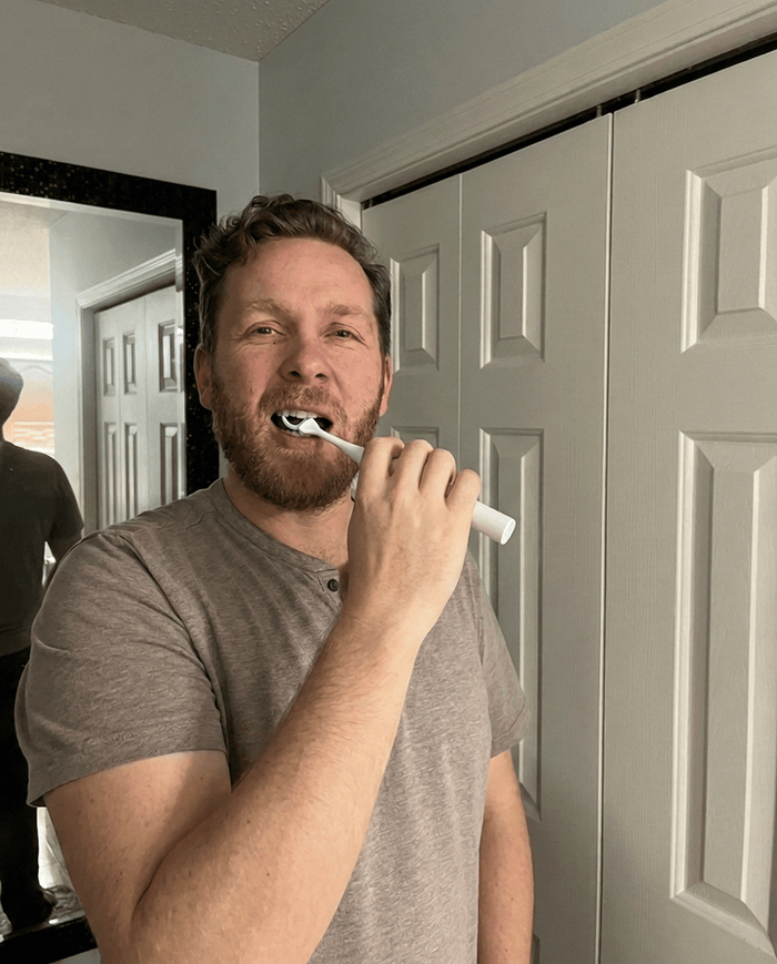 Greg W. using the Essoon flosser at home