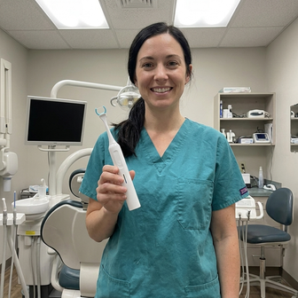 Dental hygienist holding Essoon in her practice