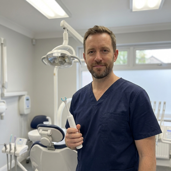 Dentist holding Essoon in his operatory