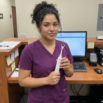 Dental office staff holding Essoon at reception