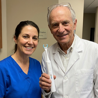 Two dentists holding Essoon together